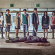 The high school cast of the Korean drama All of Us Are Dead, standing over a dead zombie.